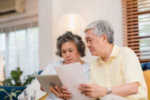 A senior couple reviewing their estate plan to prevent family disputes and ensure a smooth inheritance process.