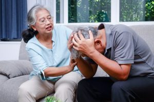 Person holding their head in distress, symbolising the impact of mind disorders and the importance of mental health awareness.